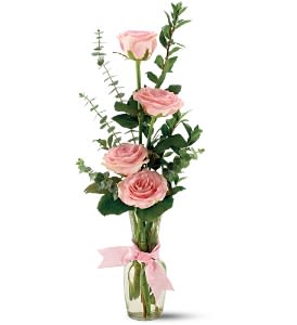 Pink roses in a clear glass vase with a pink ribbon