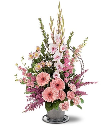 Tall pink and white floral arrangement with gerbera daisies and carnations in a gray vase