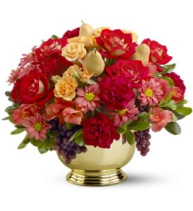 Low gold bowl arrangement of red roses, pink mums, peach roses and fruit accents