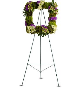 Floral wreath on a metal easel with purple and white flowers