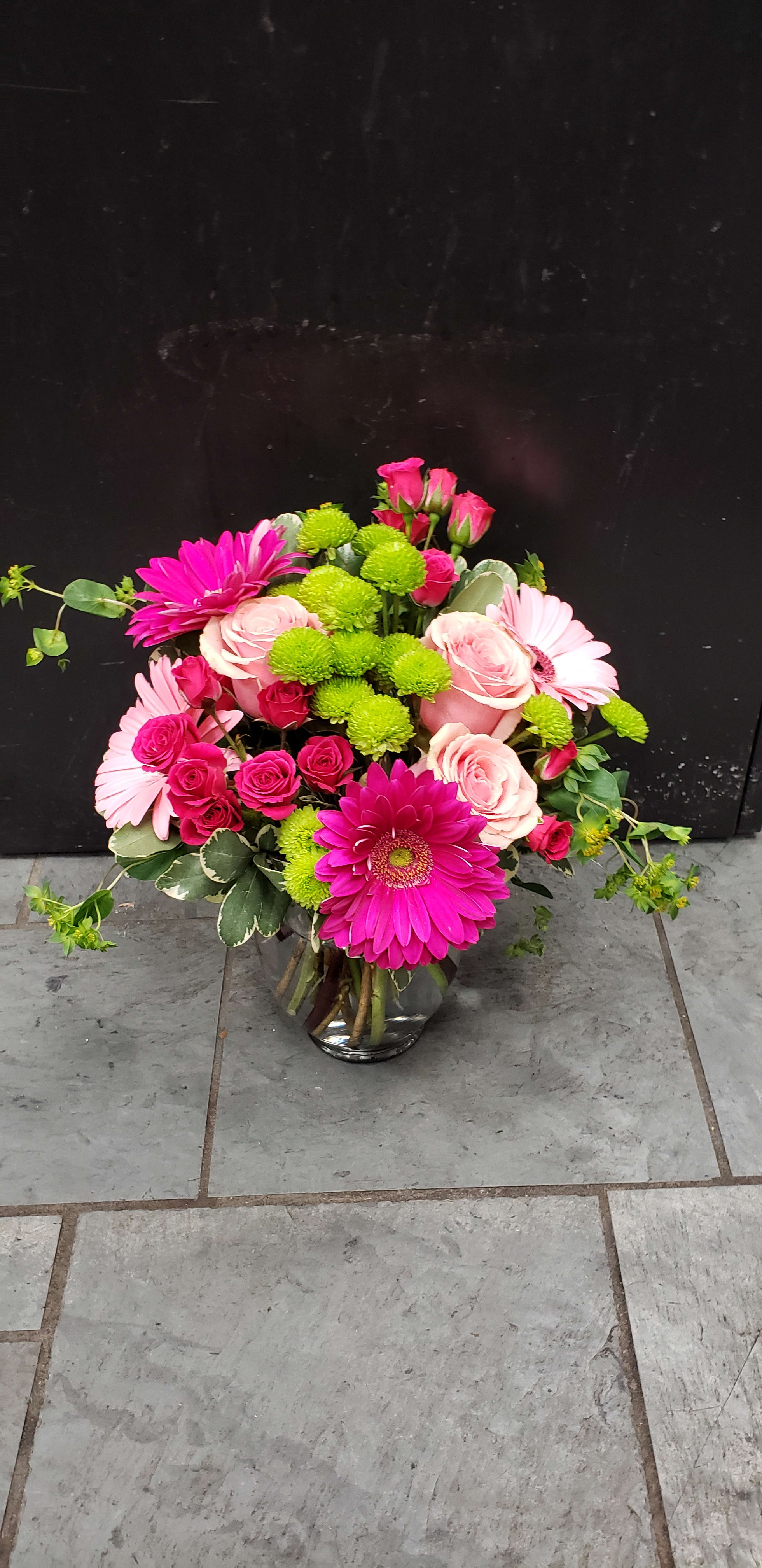 Pink and green mixed bouquet in a glass vase