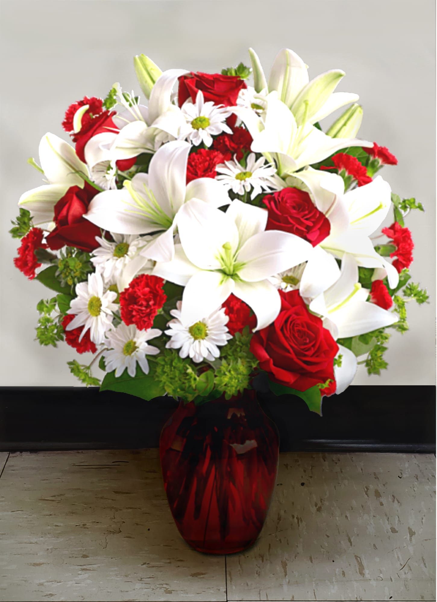 Bouquet of red roses, white lilies, and white daisies in a red vase
