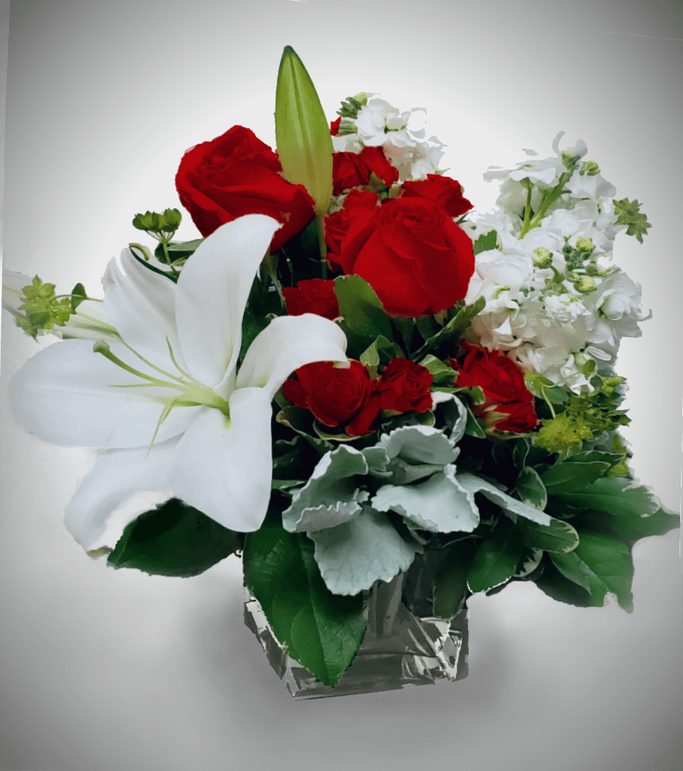 Red roses and white lilies in a clear glass vase