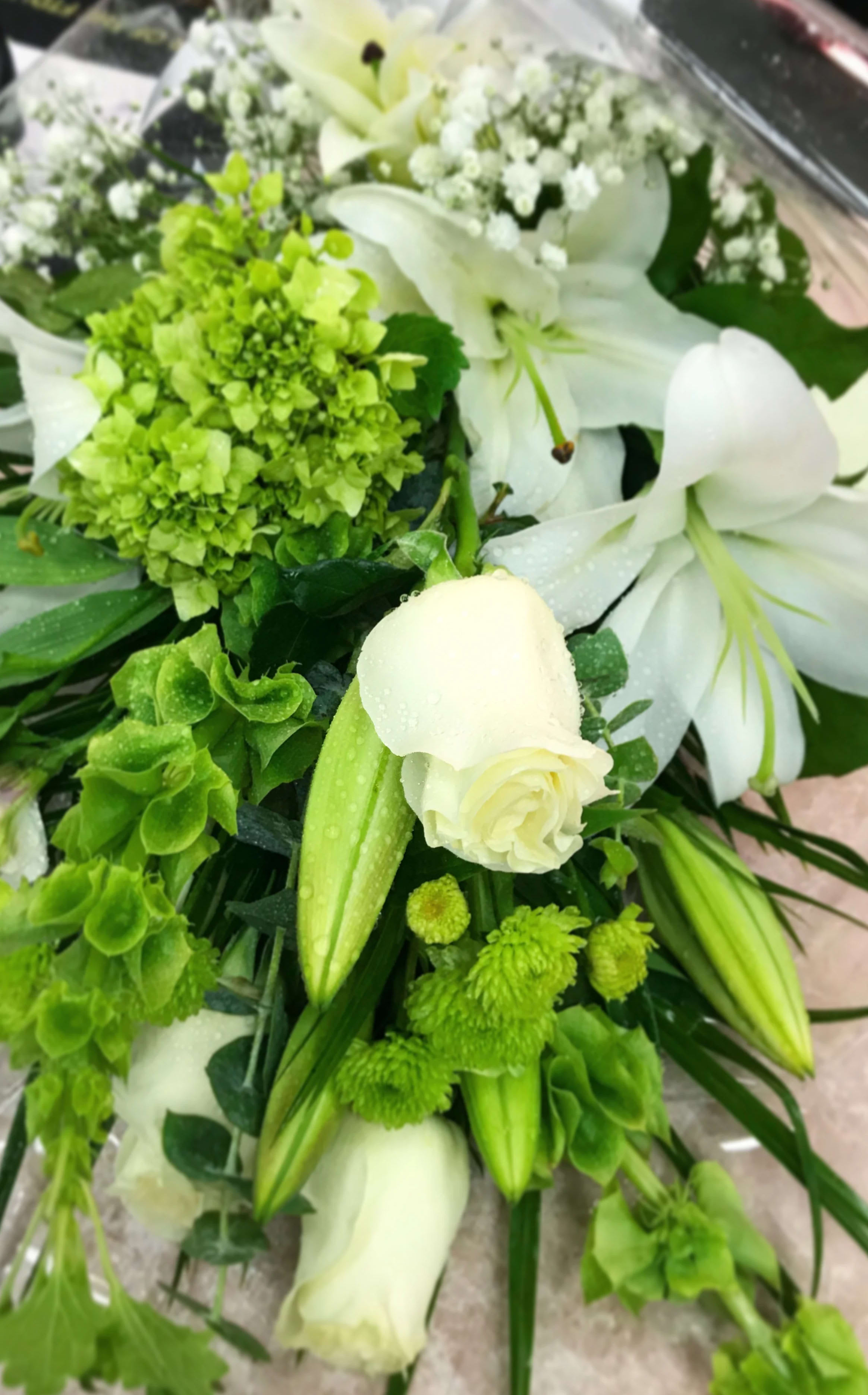 White lilies and green flowers in a bouquet