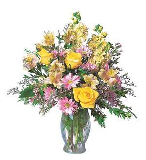 Mixed bouquet of yellow roses and pink daisies in a glass vase