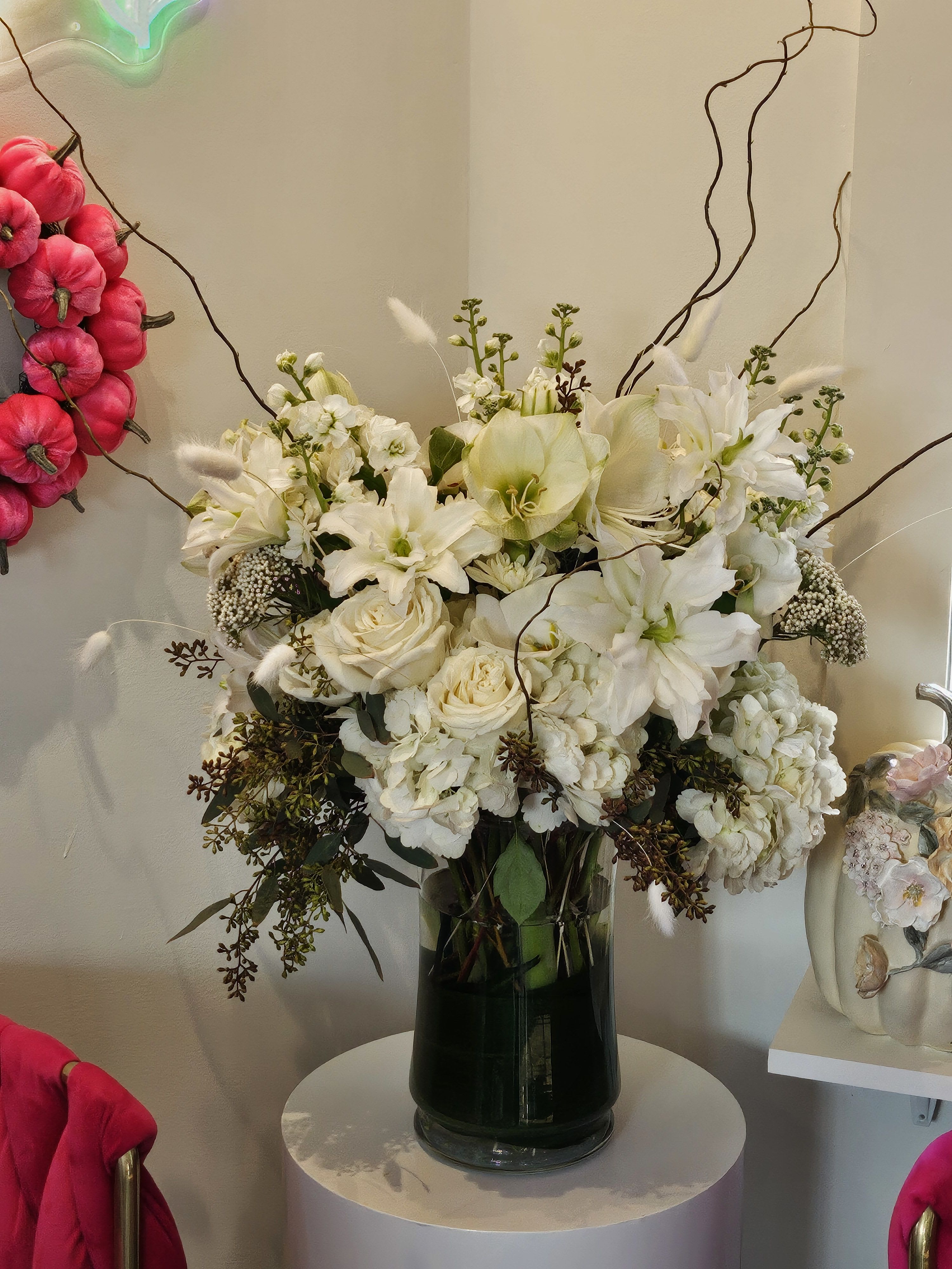 White floral arrangement in a dark glass vase