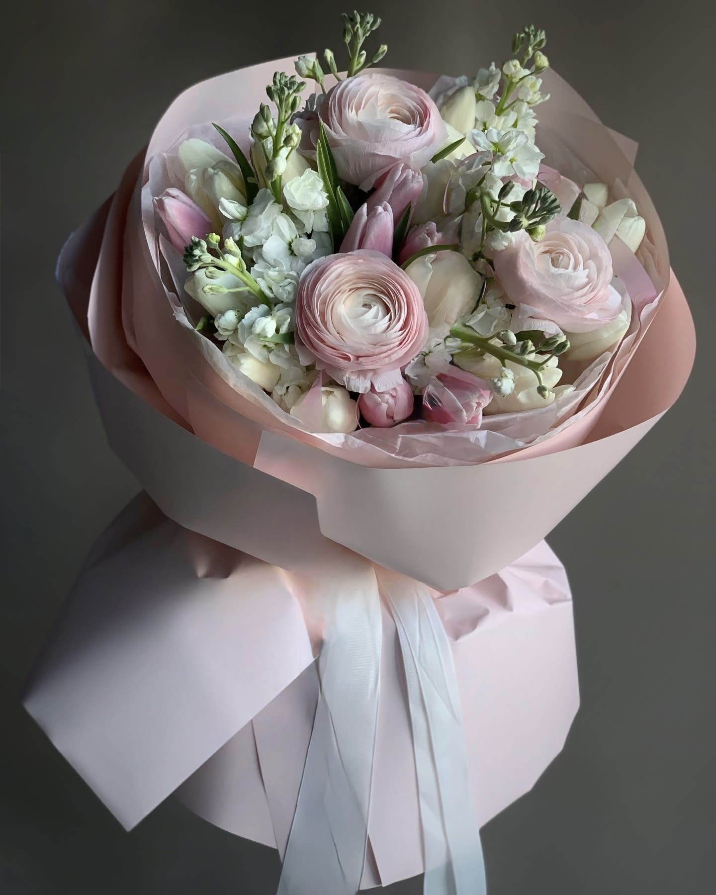 Pink and white bouquet wrapped in pale pink paper