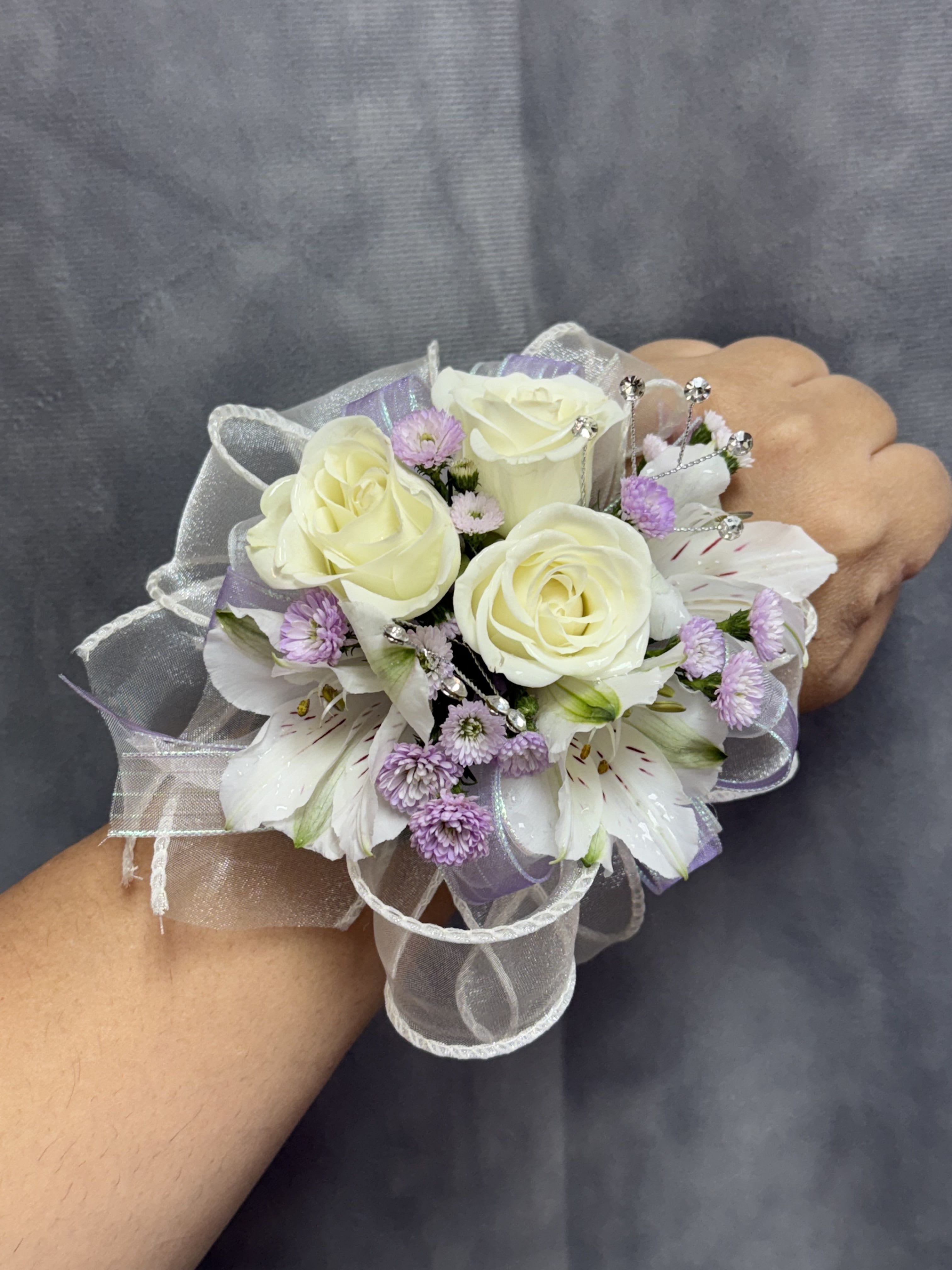 White lavender alstroemerias spray roses corsage - Cream-white spray roses and white alstroemeria with lavender fillers on a sheer ribbon and a pearl wrist band corsage-soft, elegant tones perfect for prom