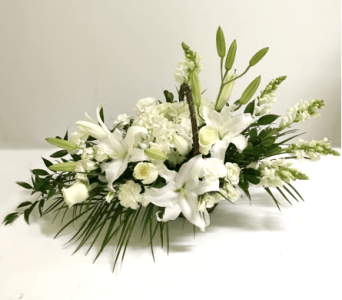 White lily and rose floral arrangement with greenery