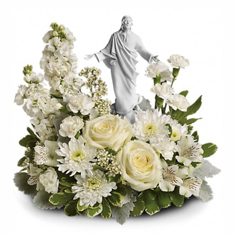 Forever Faithful Bouquet [T278-3A] - An elegant display of faith and grace, this beautiful arrangement will comfort the bereaved in a truly thoughtful and respectful way. An exquisite sculpture of Jesus is surrounded by a bed of lovely blossoms. It is sure to be appreciated and always remembered.  A fragrant mix of pure white blooms - including roses, alstroemeria, stock, carnations and waxflower - is accented with dusty miller and variegated pittosporum. Delivered with an exclusive Sacred Grace keepsake.  Approximately 14 1/2" W x 13 1/2" H  Orientation: One-Sided  As Shown : T278-3A Deluxe : T278-3B Premium : T278-3C