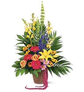 Tropical flower arrangement in a basket with bright mixed blooms