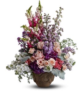  In the Garden [TFWEB557] - In the garden, fresh flowers bloom and nature's beauty reigns. Send this pastel medley of blossoms to a residence, funeral home or memorial service to show your deep devotion and affection.  A mix of fresh flowers such as roses, delphinium, stock, snapdragons, hydrangea and Monte Cassino asters is arranged in Teleflora’s Garlands of Grace urn.  Approximately 20" (W) x 26" (H)  Orientation: One-Sided      As Shown : TFWEB557  