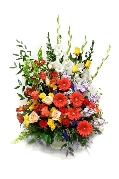 Colorful mixed bouquet with roses, gerbera daisies, and white gladiolus