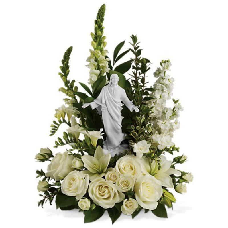 Garden of Serenity  [T229-1A] - This exquisite porcelain sculpture of Jesus surrounded by radiant flowers will be a source of comfort to loved ones during a time of loss. Your thoughtfulness will be long remembered.  The stunning bouquet includes white roses, stock, snapdragons, lilies and freesia accented with salal, myrtle and pittosporum. Delivered with a meticulously detailed porcelain sculpture of Jesus.  Approximately 15 3/4" W x 22" H  Orientation: One-Sided  As Shown : T229-1A