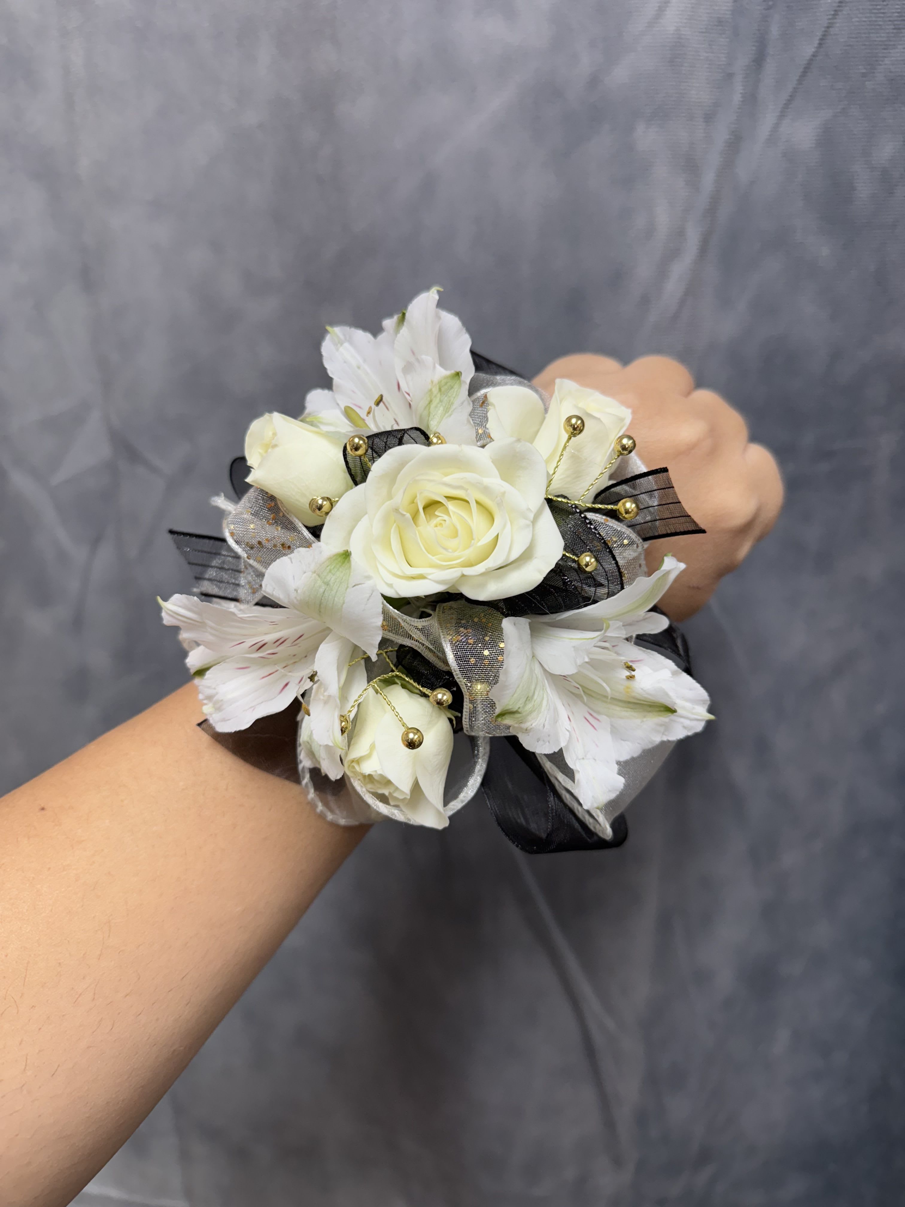 White spray roses alstroemeria black corsage  - Cream-white spray rose with white alstroemeria, black and white ribbons, and gold bead accents on a pearl wrist band corsage elegant for prom