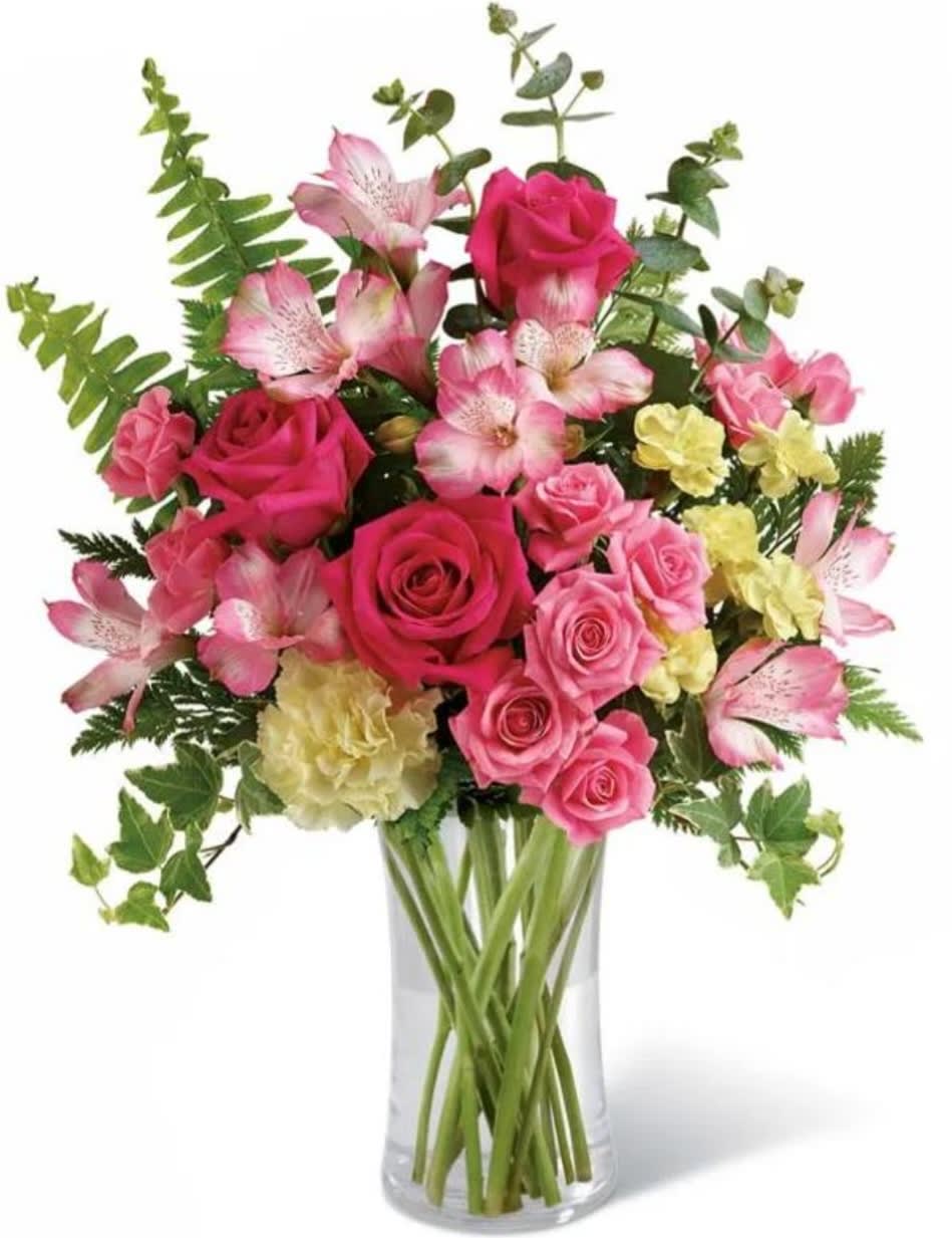 Pink roses and alstroemeria in a clear glass vase