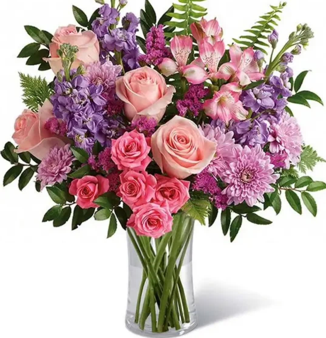 Pink and purple mixed bouquet in a clear glass vase