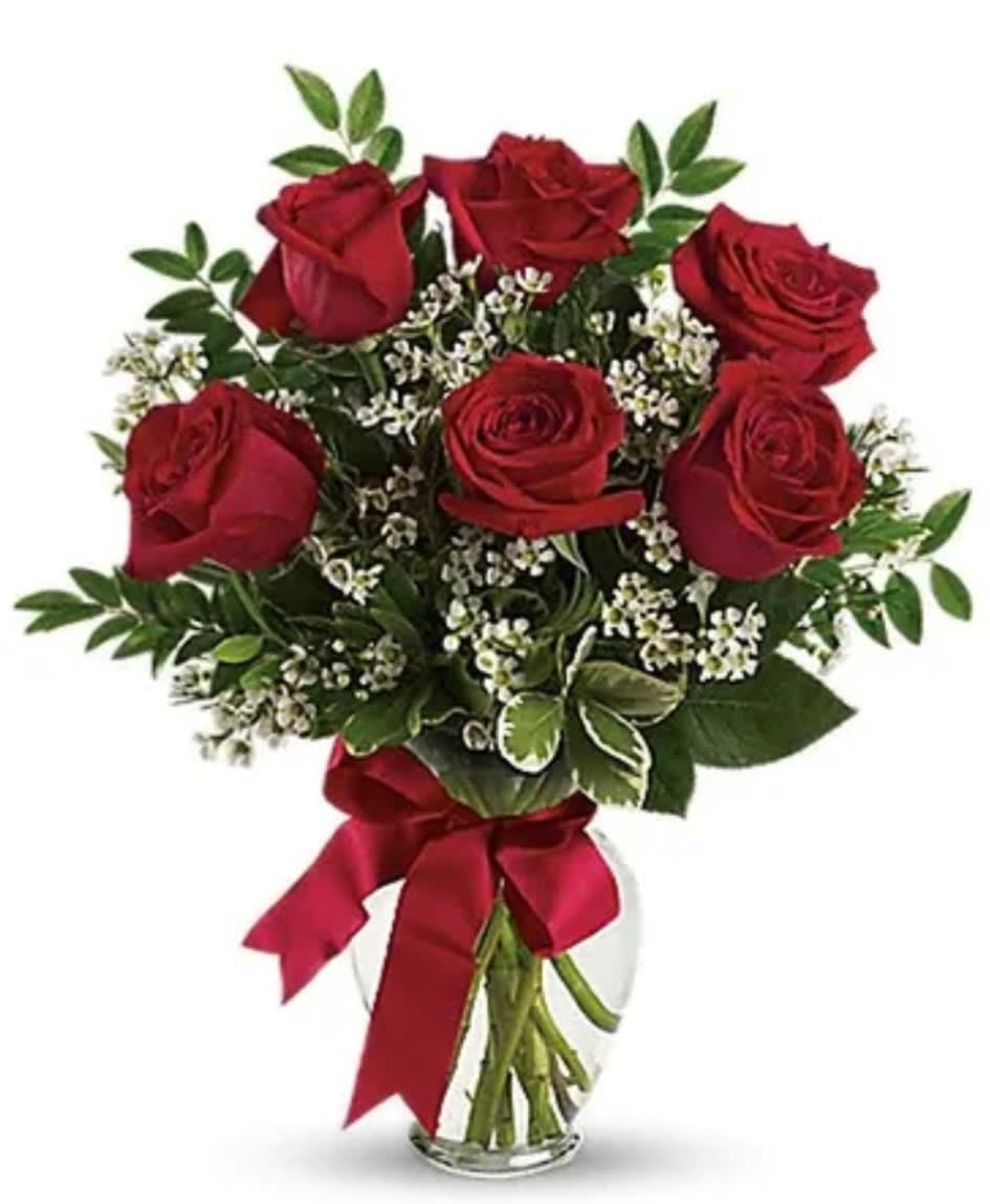 Bouquet of red roses with baby's breath in a clear glass vase
