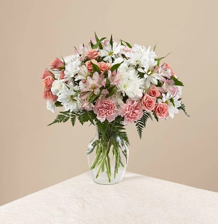 Pink and white mixed bouquet in a clear glass vase