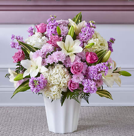 Pink and white mixed flower arrangement in a white vase