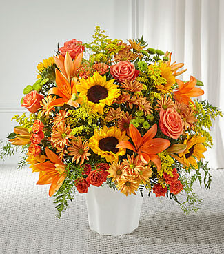 Orange and yellow mixed bouquet in a white vase