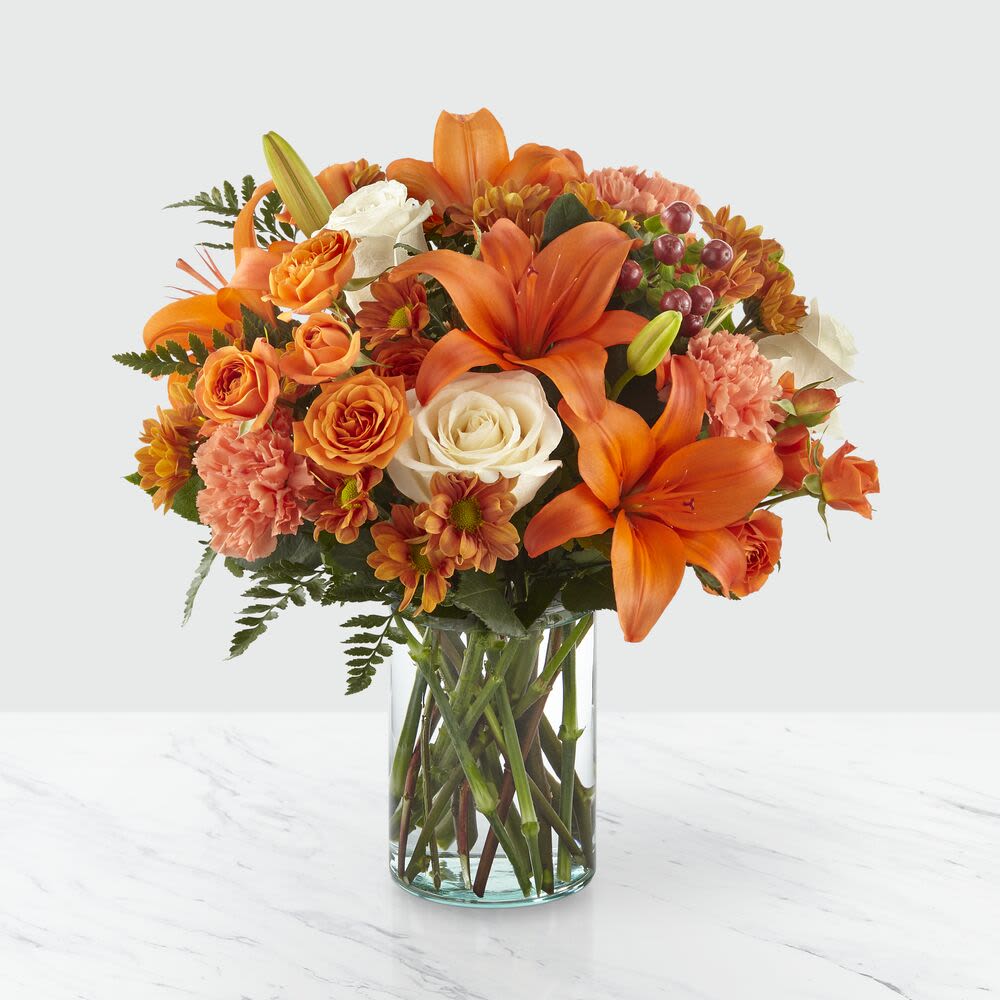 Falling For Autumn - The harvest season just got even more beautiful with our Falling for Autumn Bouquet. Reminiscent of vibrant Autumn trees and falling leaves, this arrangement is comprised of cream roses, orange spray roses, Asiatic lilies and carnations. Give this bouquet to your loved ones and watch their face light up from its radiant beauty. 