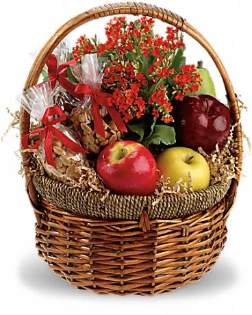 Basket of red flowers with apples and wrapped treats