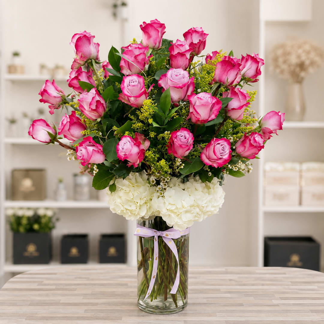 Pink roses and white hydrangeas in a clear glass vase