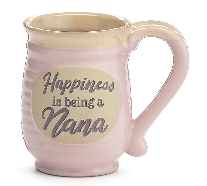 Pink ceramic mug with beige rim and oval plaque reading “Happiness is being a Nana.”