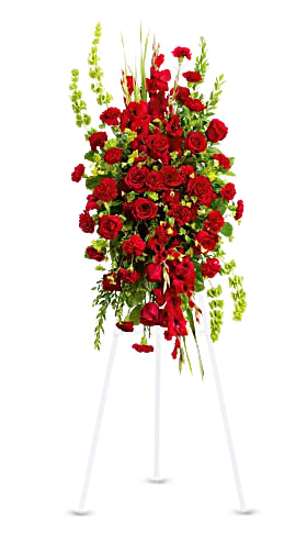 Tall red rose and carnation standing spray on a white easel
