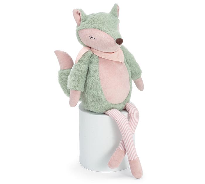 Plush fox toy sitting on a white cylinder