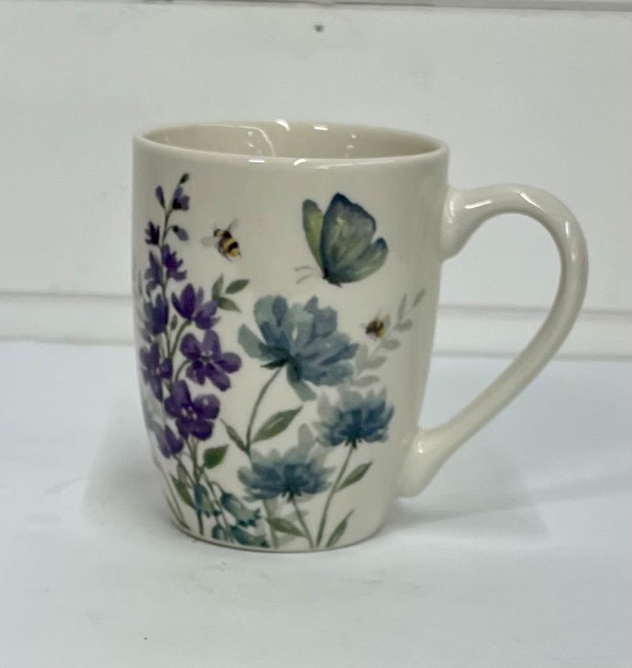 White ceramic mug with purple and blue floral and butterfly print