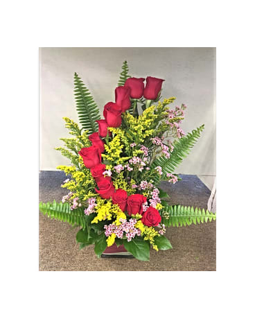 Tall arrangement of red roses with yellow and pink filler flowers