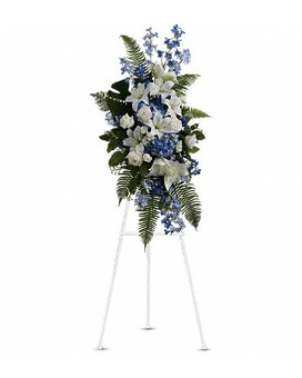 Tall blue and white floral standing spray on a metal easel