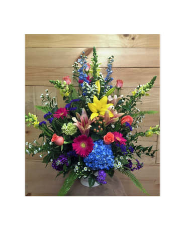 Colorful mixed flower arrangement in a white vase