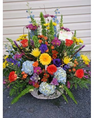 Large mixed flower basket with roses, hydrangeas, and daisies