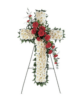 Standing floral cross with white and red flowers on an easel