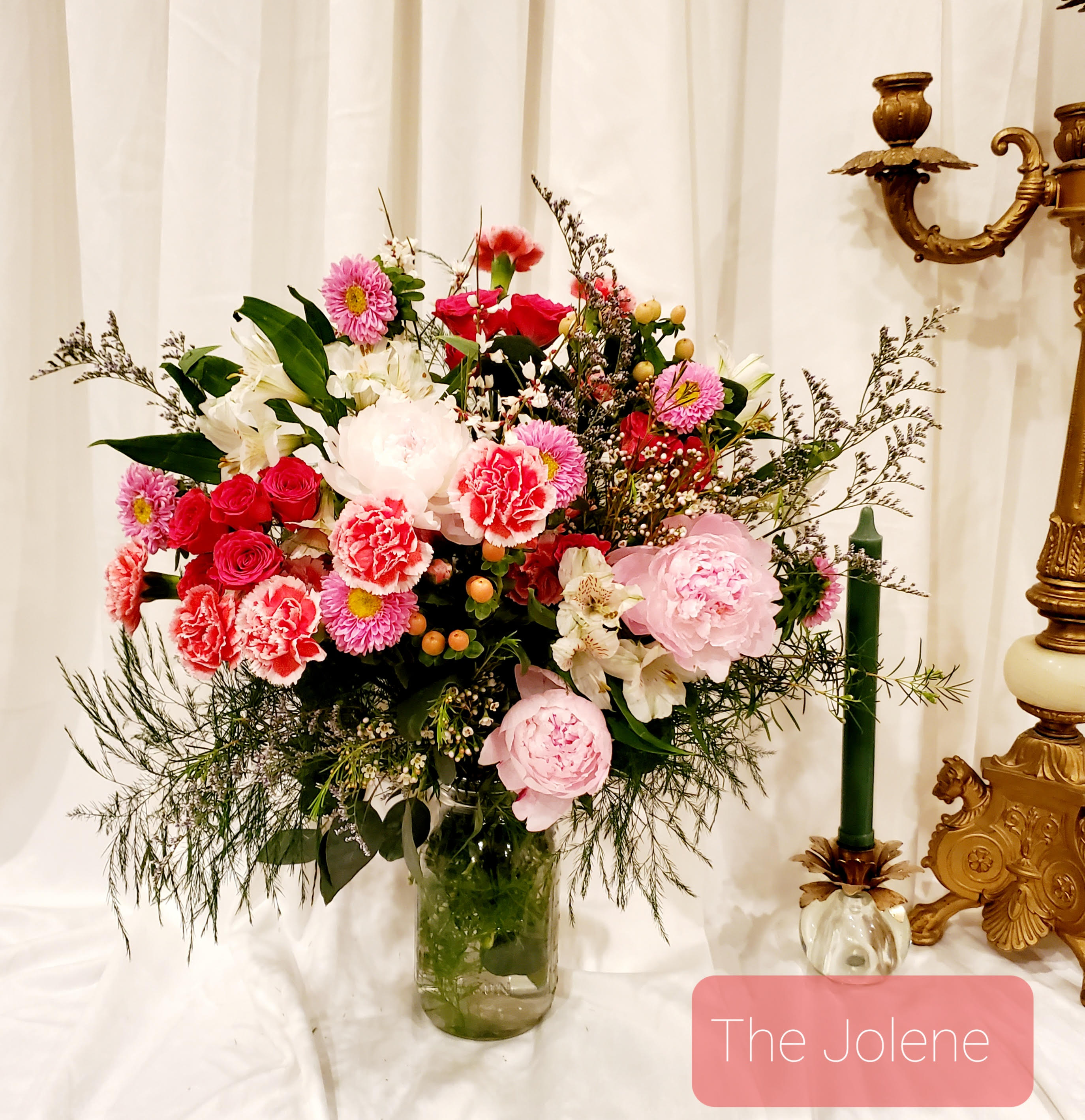 Mixed pink and white flower arrangement in a glass vase