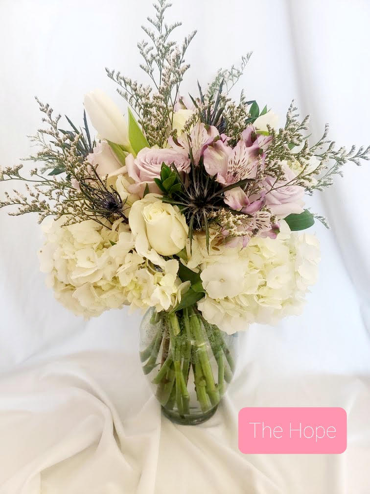 Bouquet of white and blush flowers in a glass vase