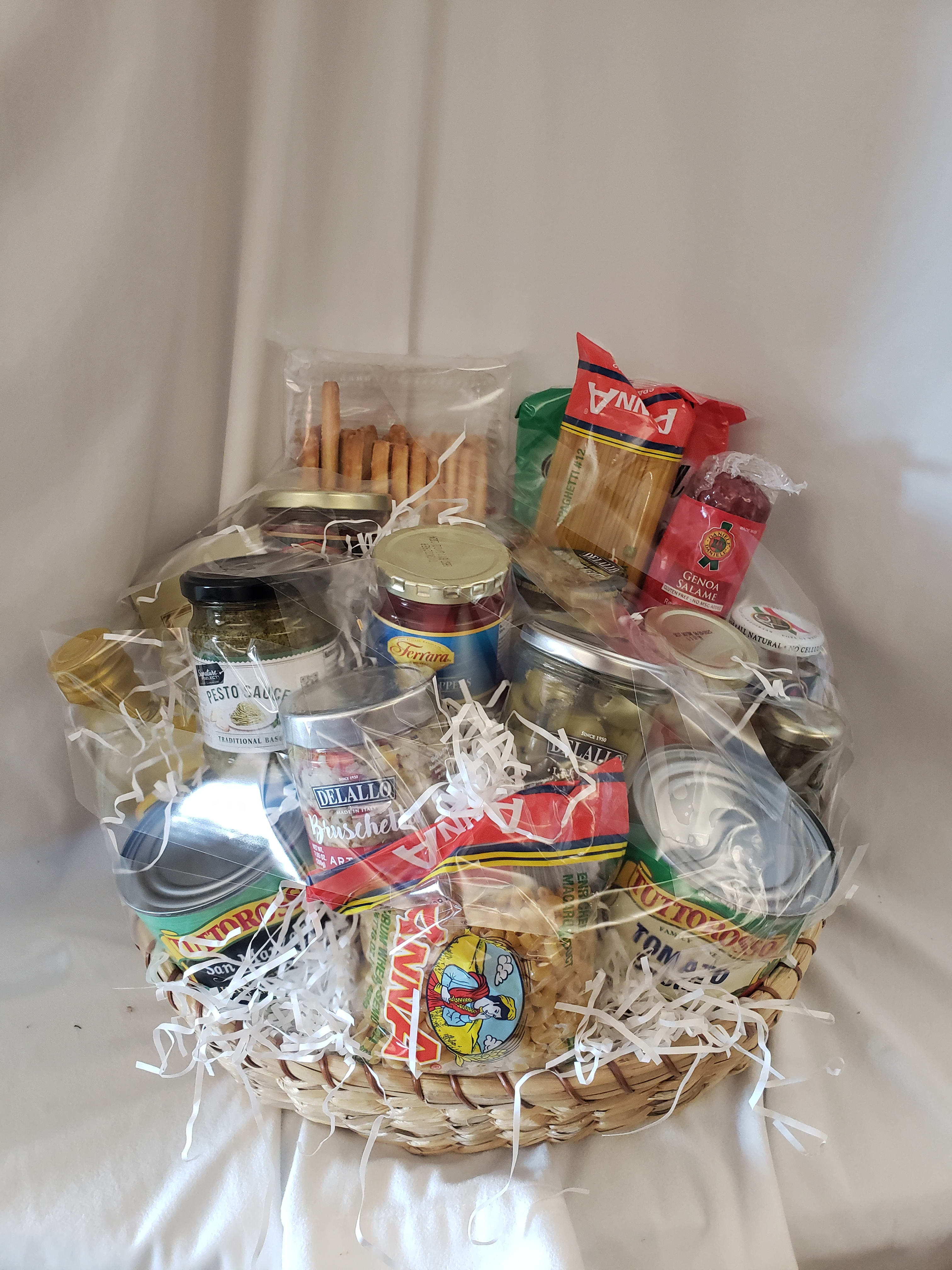 Gift basket with pasta, sauces, olives, and salami