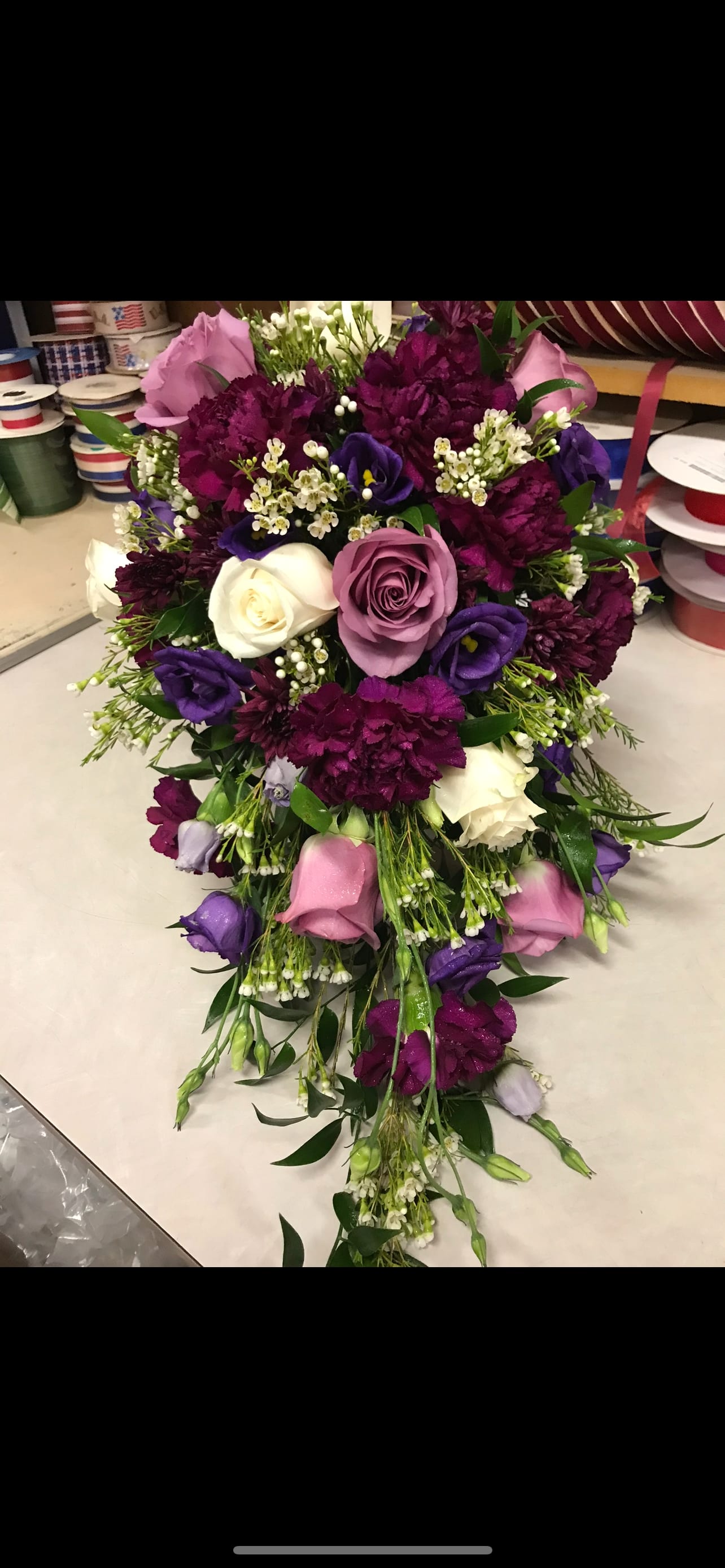 Cascade bouquet of pink, purple, and white flowers