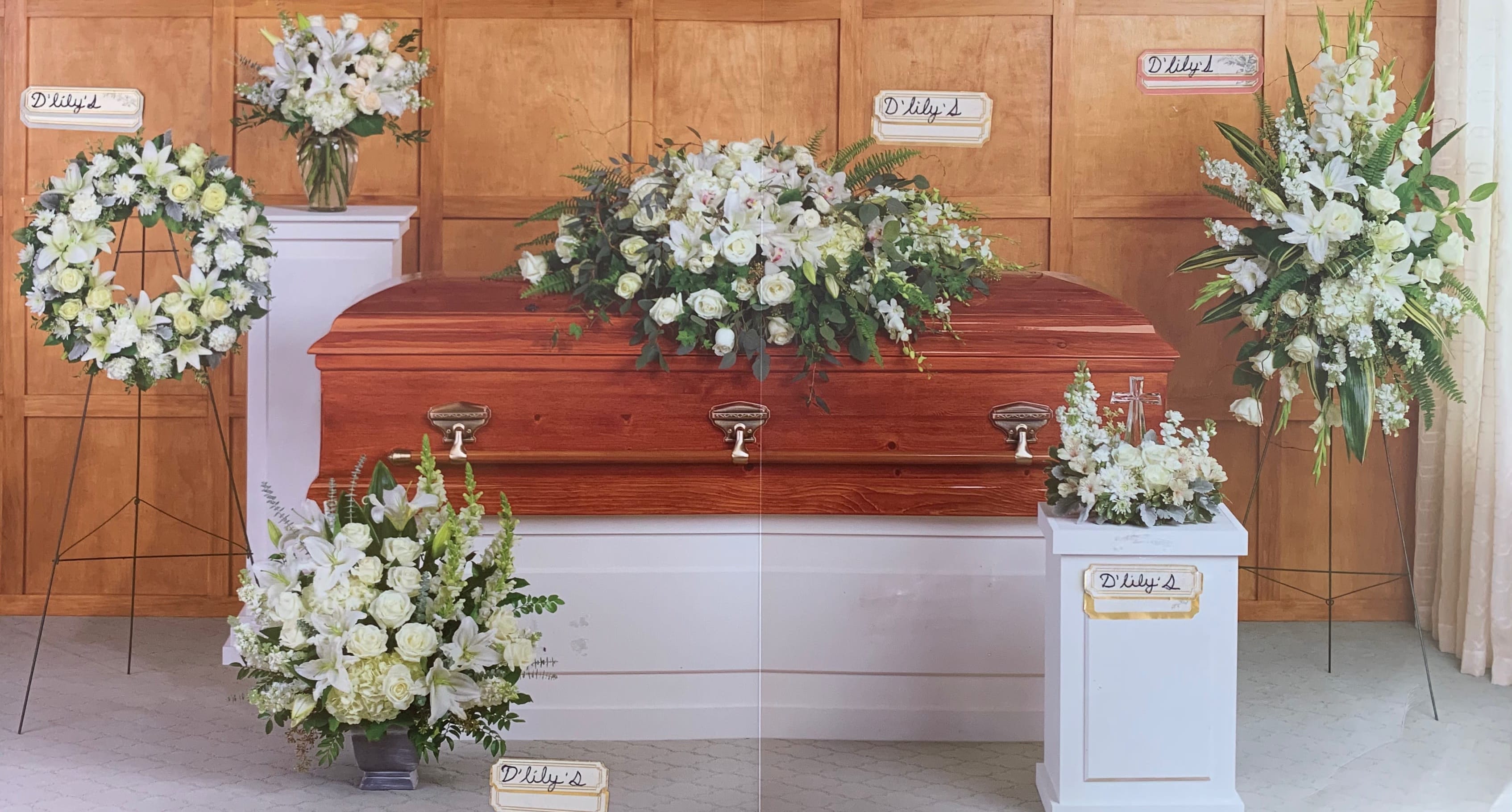 Green Collection  - Inspire your loved ones with peace and serenity with this grant assortment of six hand-made sympathy pieces, featuring pure white roses and lilies. This package consists of one wreath, casket, standing spray, Basket, and two sympathy arrangements. 