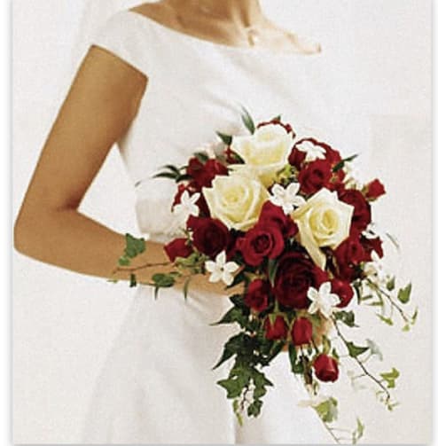 Red &amp; White Romance  - A stunning red and white wedding bouquet. It includes a mix of red and white roses, a couple red spray rose with a nice touch of white stephanotis and some complementary ivy.   Disclaimer: Flowers may be substituted if needed to. 