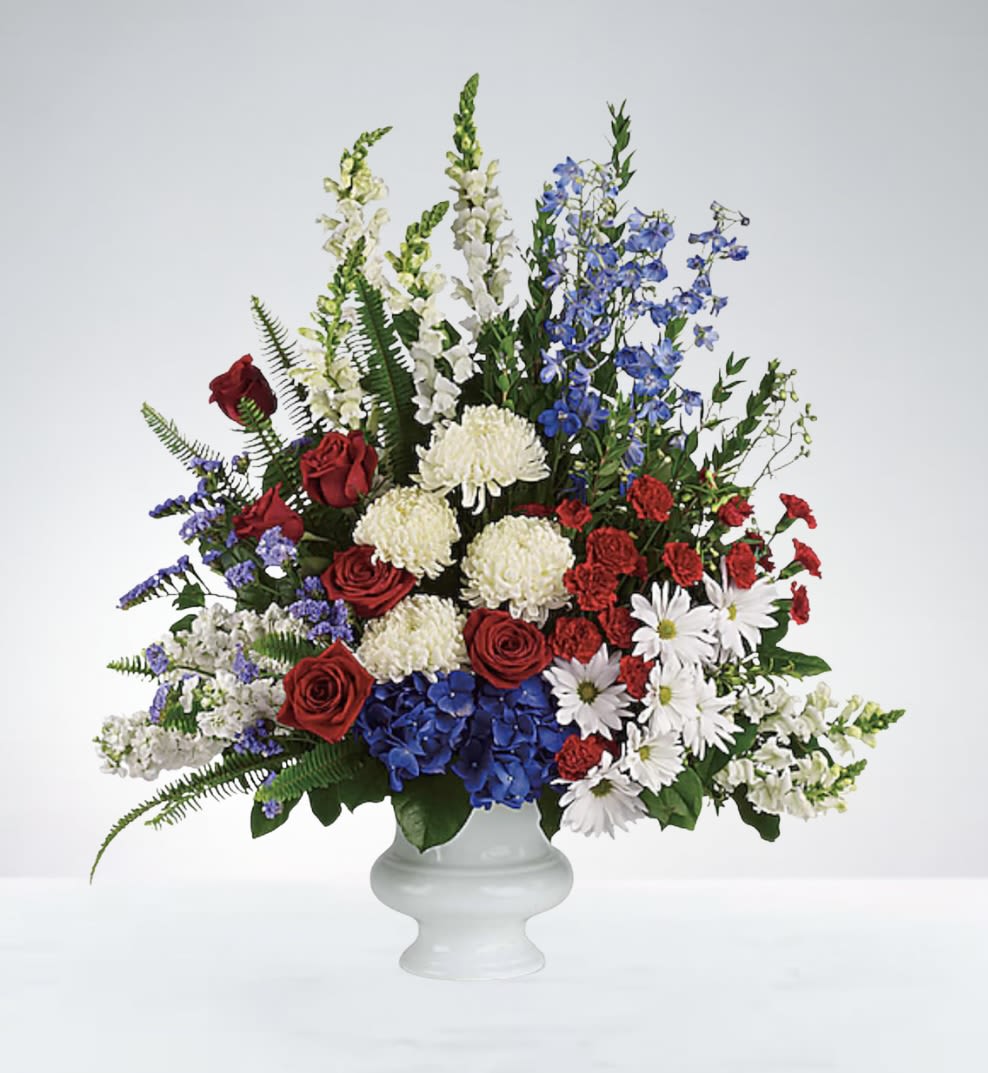 Freedom Blooms - A patriotic mix of red, white, and blue flowers arranged in a basket—perfect for honoring service, remembrance, or national pride. 