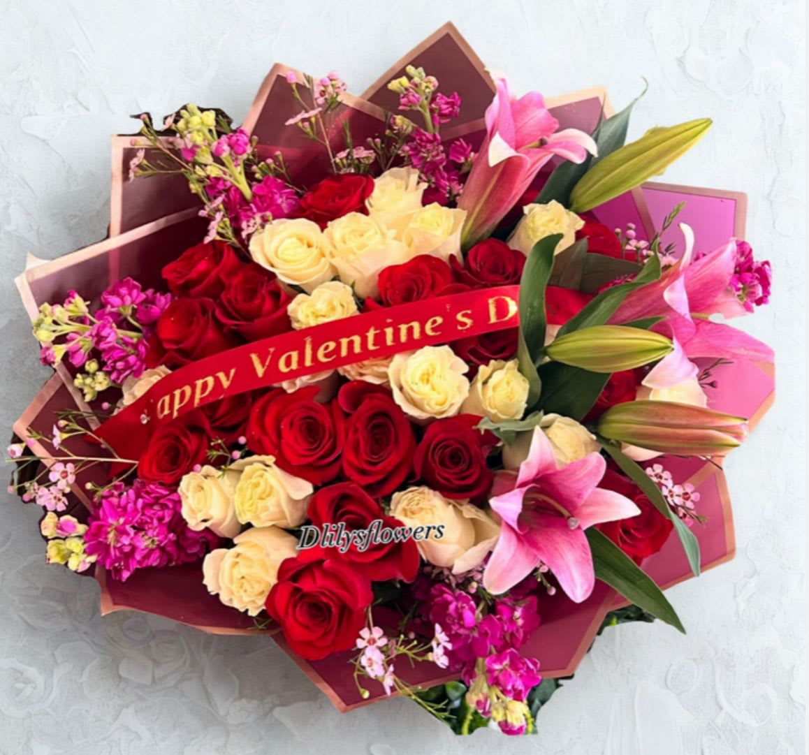 Valentine’s Day Special ️ by D'Lily's Flowers  - A beautiful grand gesture to show them how appreciative and loved they are! Made Of 3 dozen red and white roses with stock and lilys and an added ribbon for Valentine’s day! Disclaimer: This is a wrapped bouquet. No Vase is Included. 