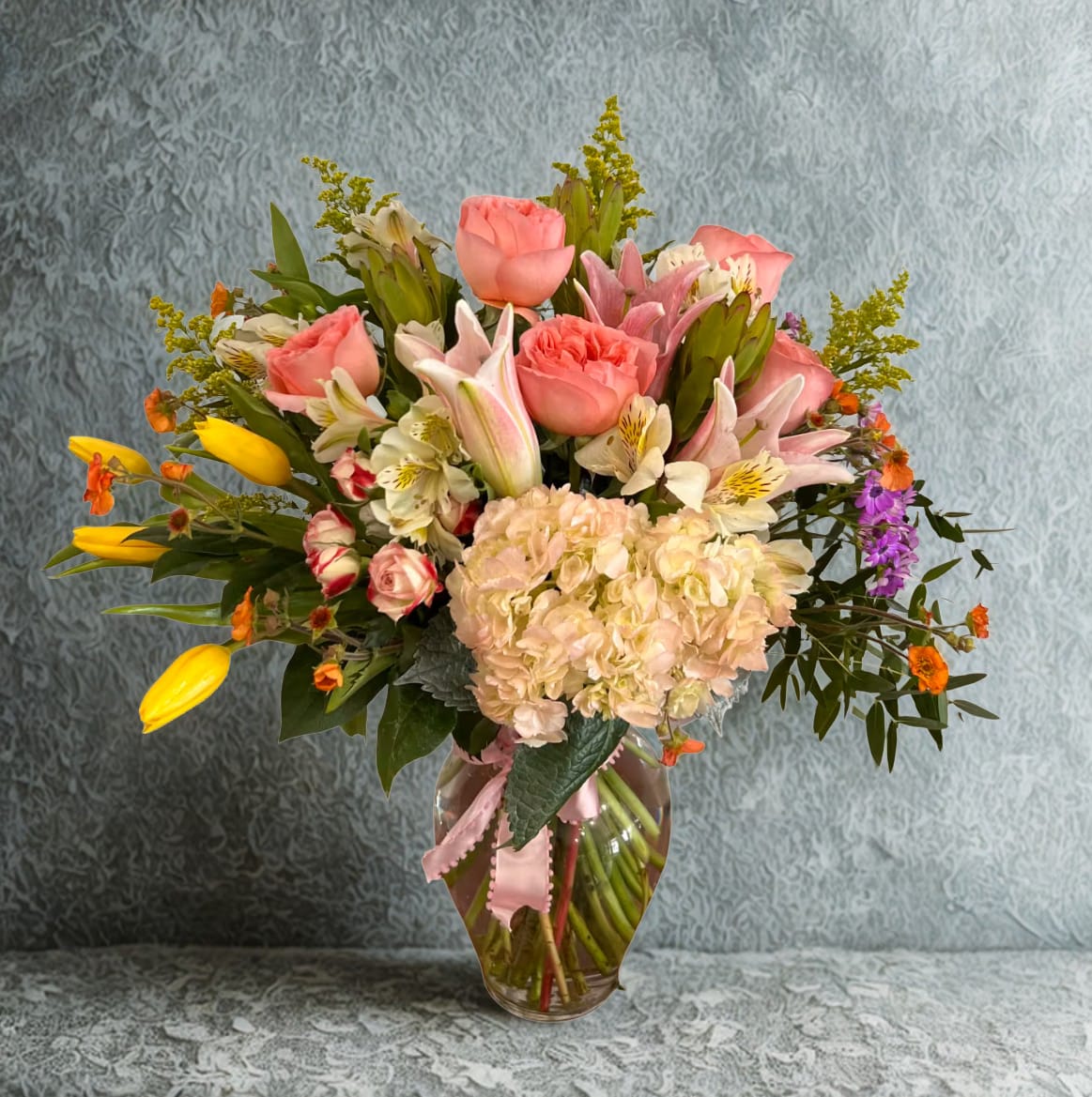 Sweetness by D'Lily's Flowers  - Spring full mix of beautiful flowers combined to bring cheer, joy and happiness into someone’s life! A beautiful floral mix containing tulips, roses, ranunculus, lilys, safari, greens and a hydrangea !   DISCLAIMER: Flowers may be substituted if necessary. 
