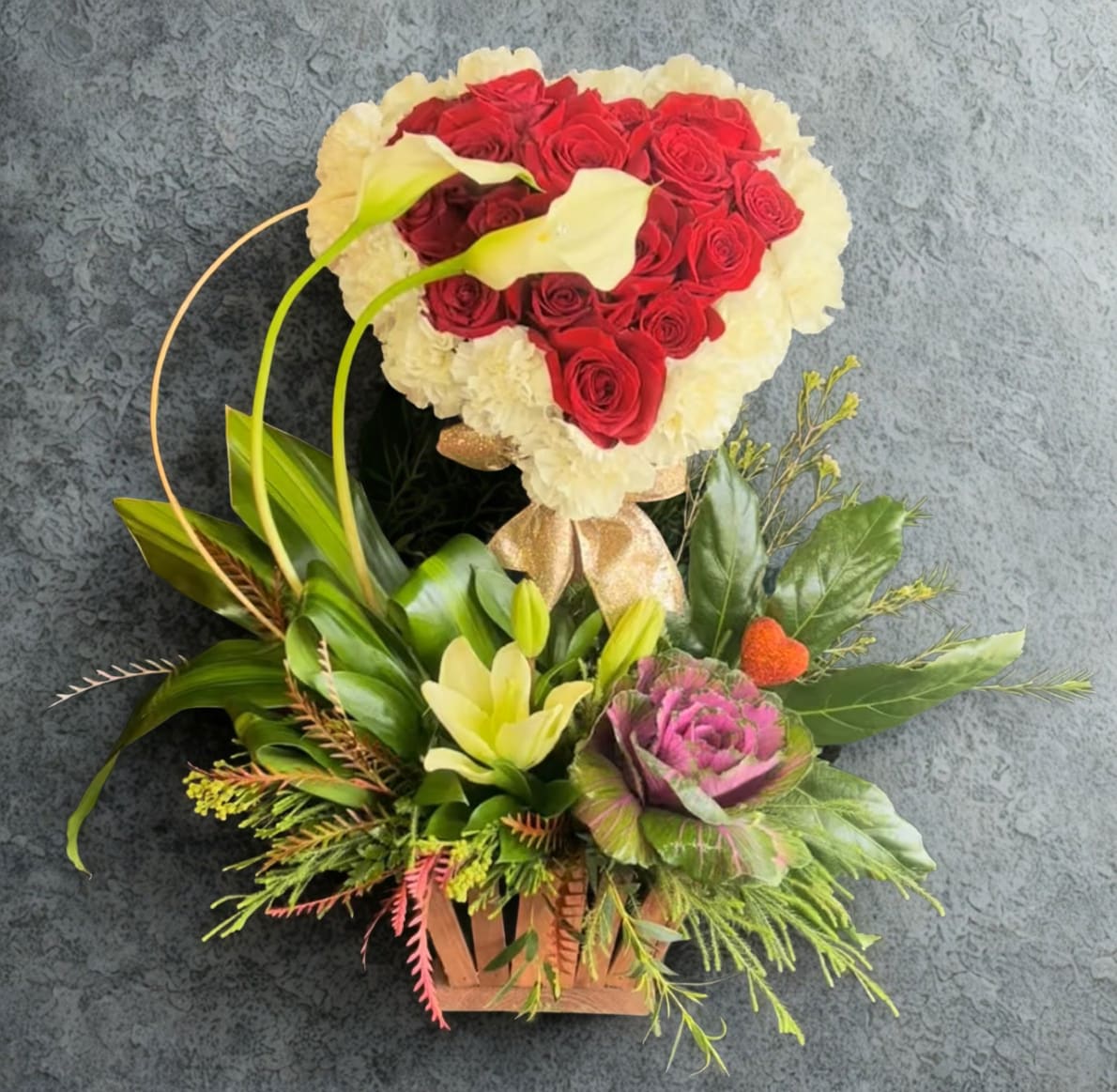 Amor Bueno  by D'Lily's Flowers  - This grand arrangement holds a mix of red roses and carnations on the top layer, making a heart shape. On the bottom of the arrangement jus a great mix of greens with a couple flowers for an extra touch of grand. 