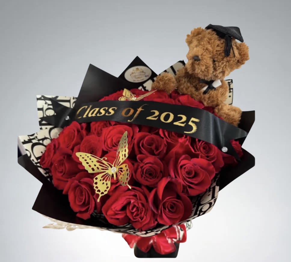 "Class Of "  Bouquet  by D'Lily's Flowers  - A wonderful way to show your grad just how amazingly proud you are of them, to celebrate their special accomplishment! A beautiful all red rose with a graduation teddy bear and a “Class of 2025” ribbon to put to all together! Disclaimer: This is a wrapped bouquet. No Vase is Included. 