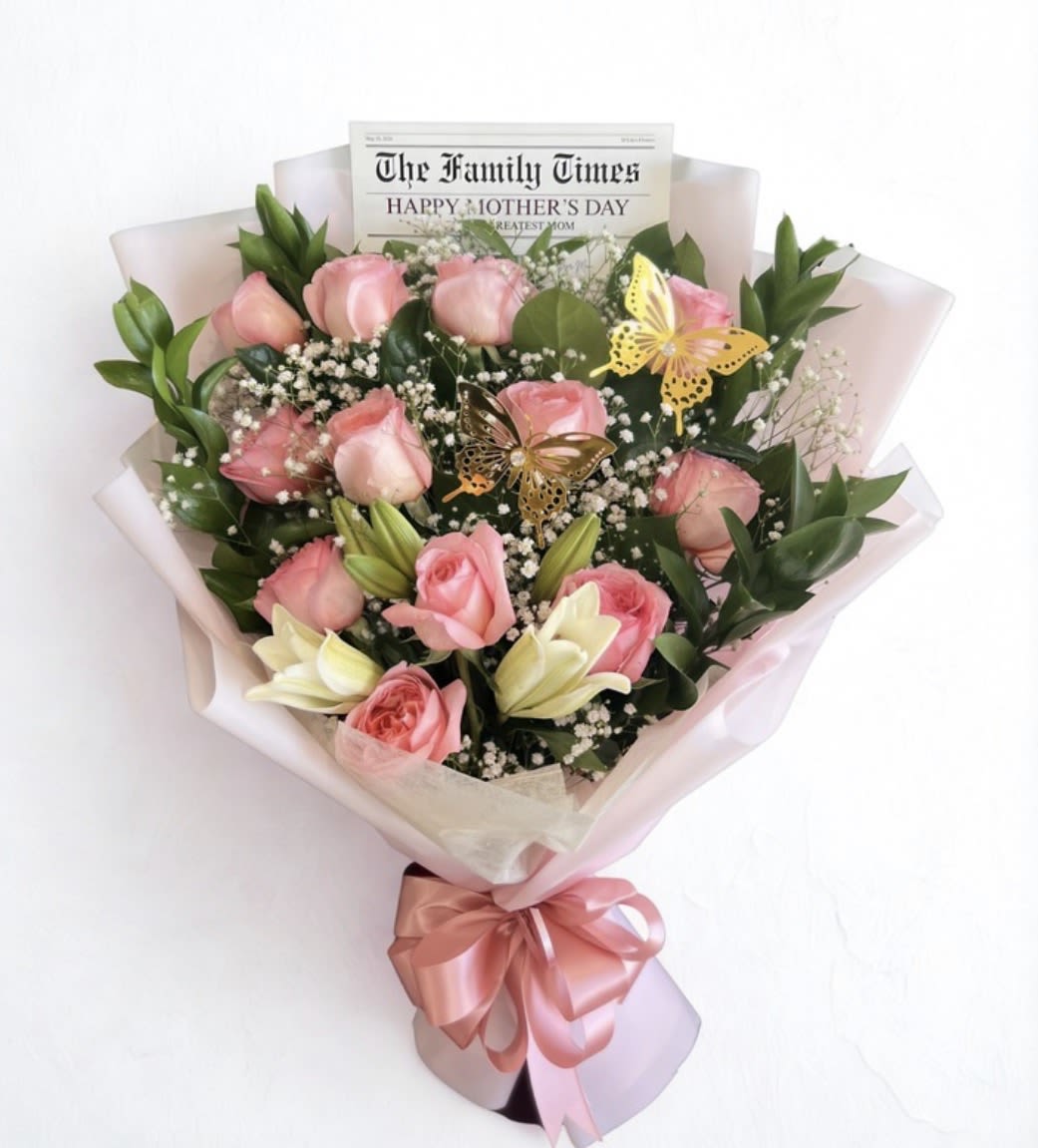 Happy Mother’s Day Bouquet  - A charming bouquet of pink roses and white lilies, accented with greenery and baby’s breath, wrapped in soft pastel paper with a pink ribbon and butterfly details—perfect for Mother’s Day. Disclaimer: This is a wrapped bouquet. No Vase is Included. 