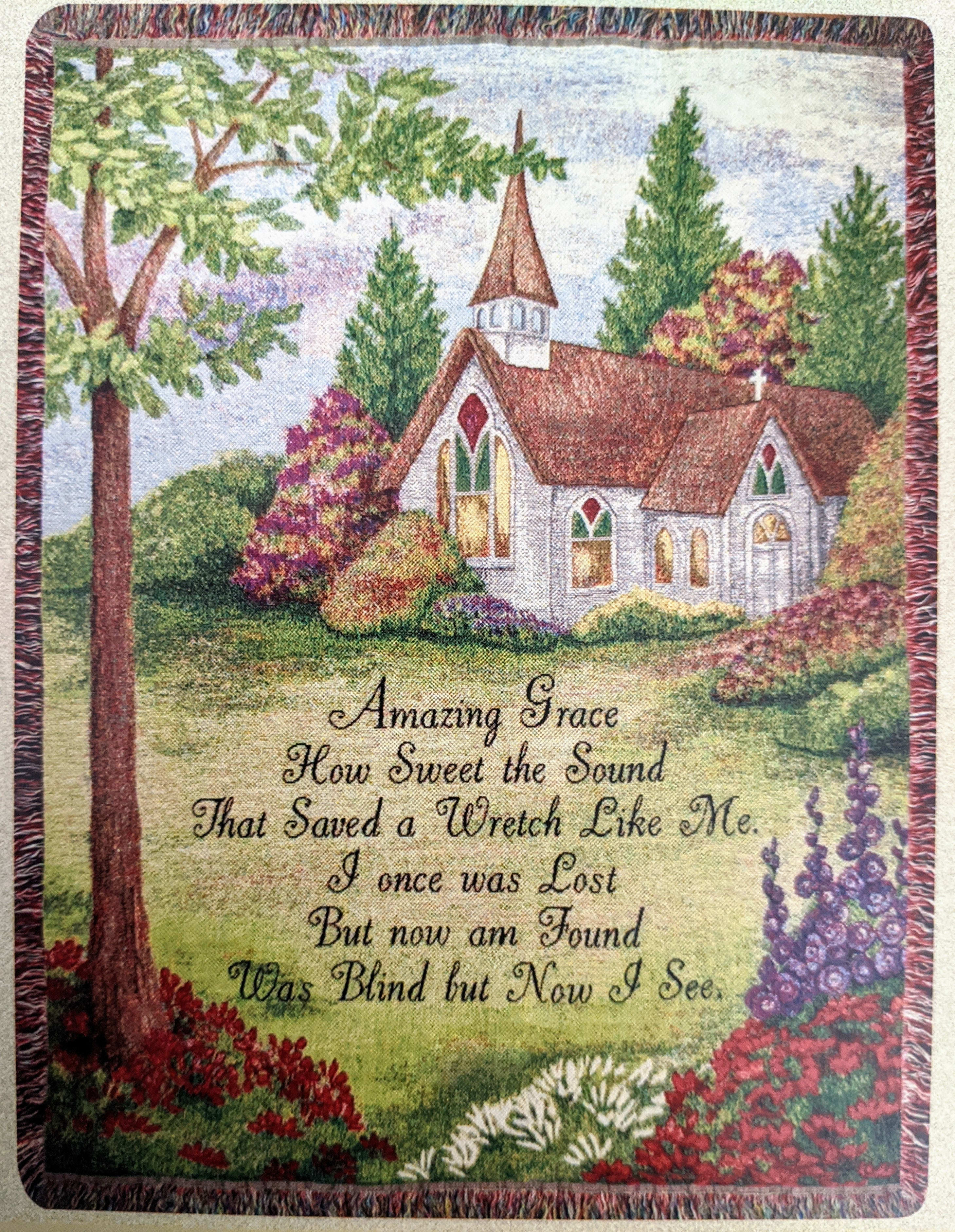 Decorative wall hanging with a church scene and printed hymn text